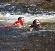 maxandmollyincurrent children swimming at bottom of water slide